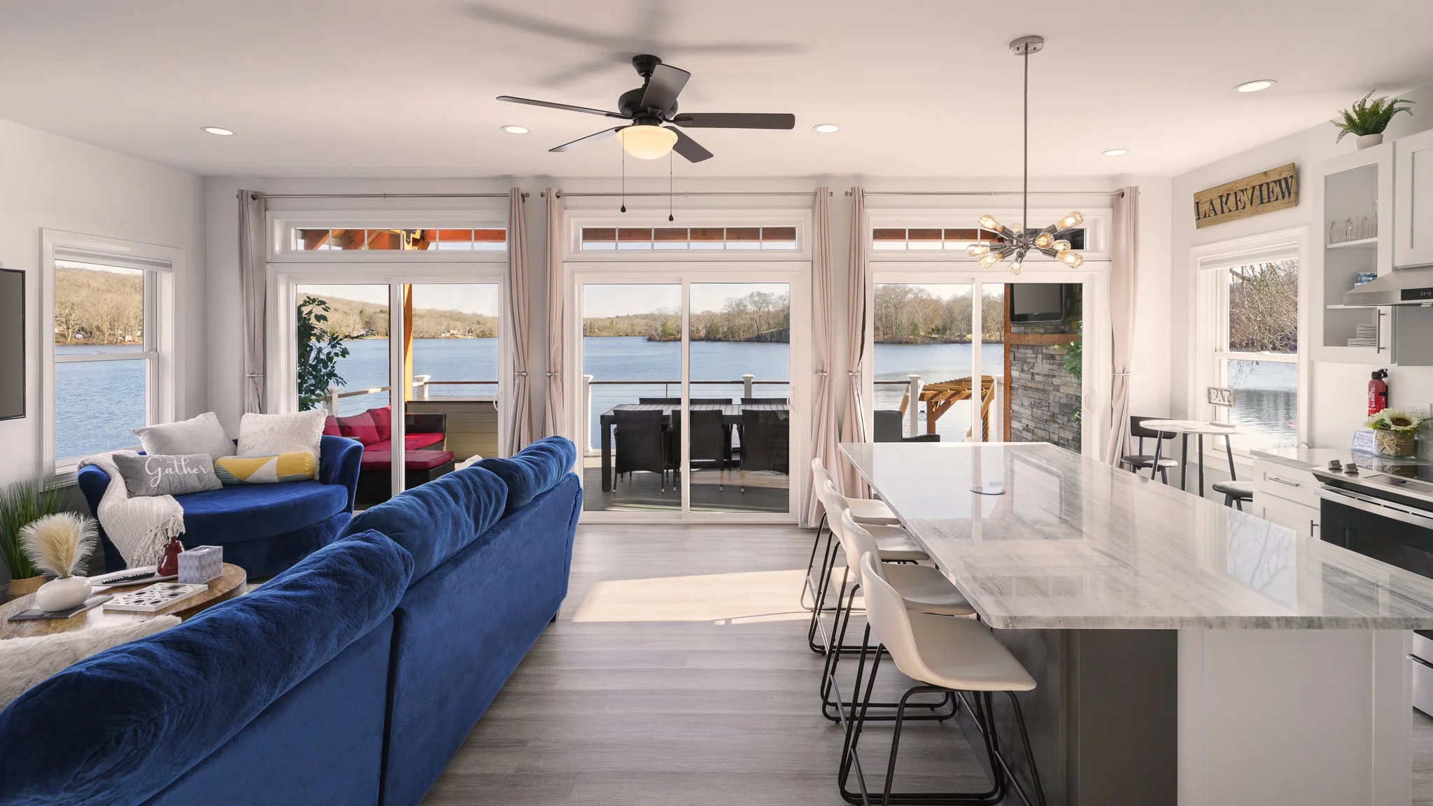 Open kitchen and living room with lake view windows at the Eagles Nest Airbnb on Amos Lake in Preston, CT.