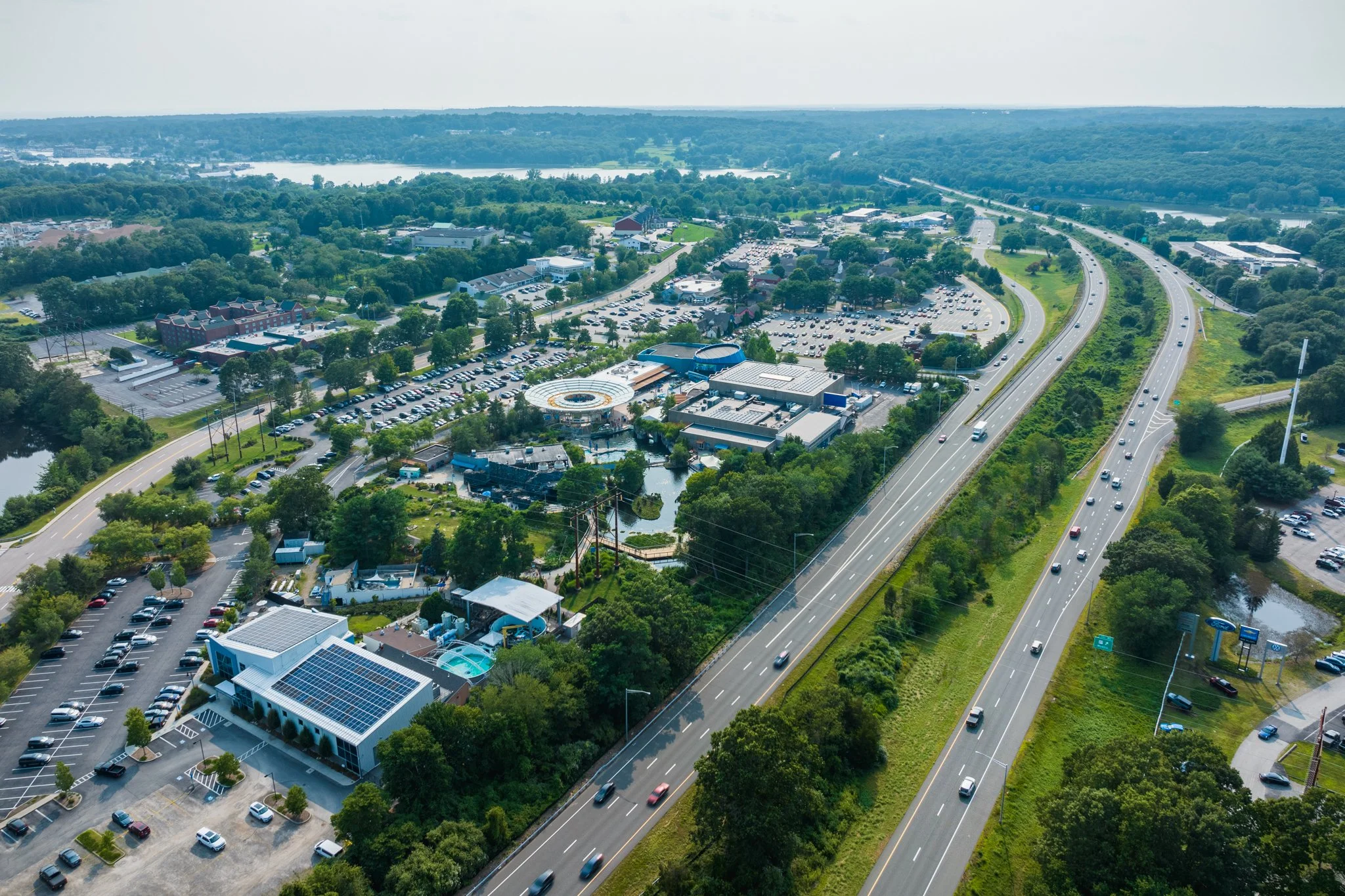Aerial drone view along Interstate 95 with the Mystic River in the distance.