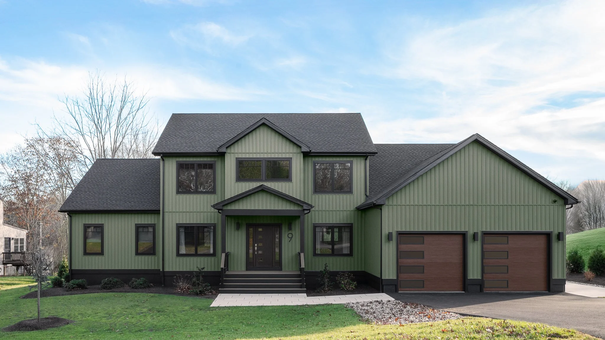 Custom home by MG Unlimited at Westerly River Run with aluminum siding, Marvin windows and a two-car garage in Westerly, RI.