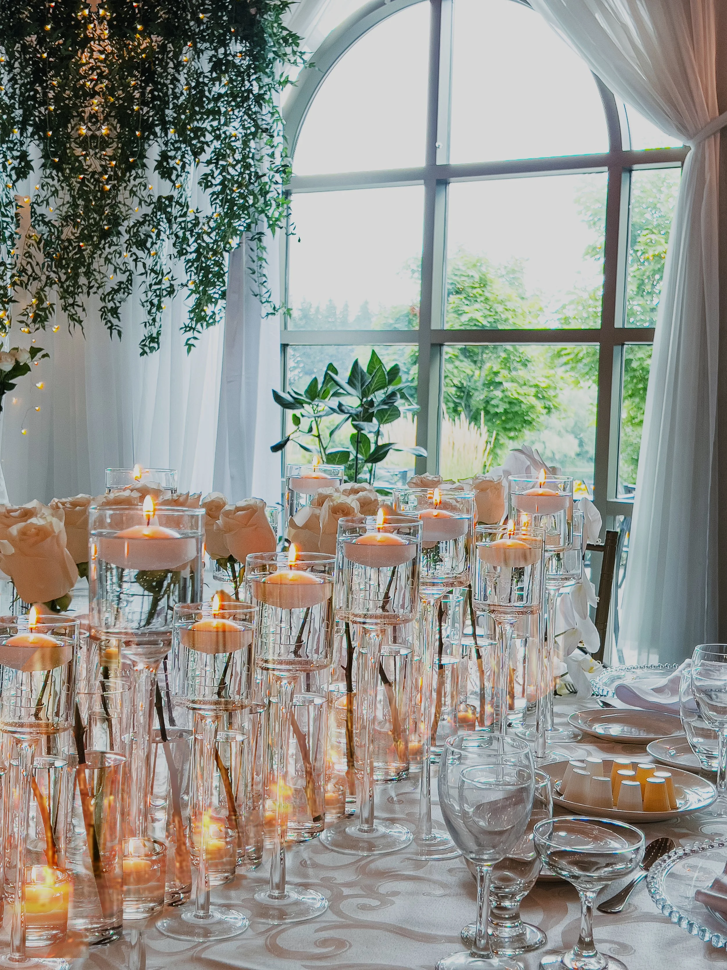 The wow design showcases long runners adorned with single stem roses, accompanied by an array of candles, creating a mesmerizing and romantic ambiance.