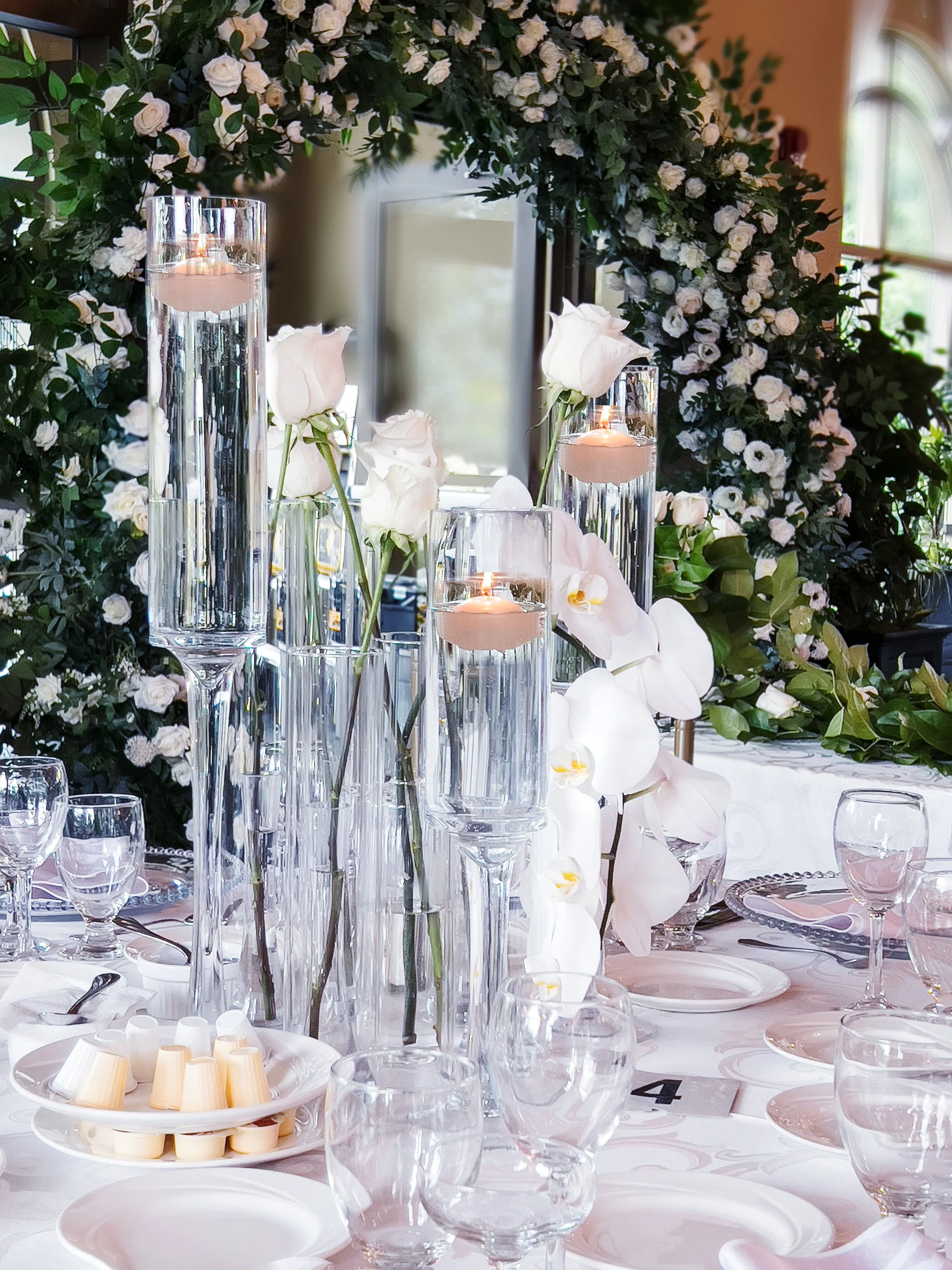 Amidst this beautiful setup, an abundance of single roses graces the scene, infusing it with a captivating charm and a timeless symbol of love.