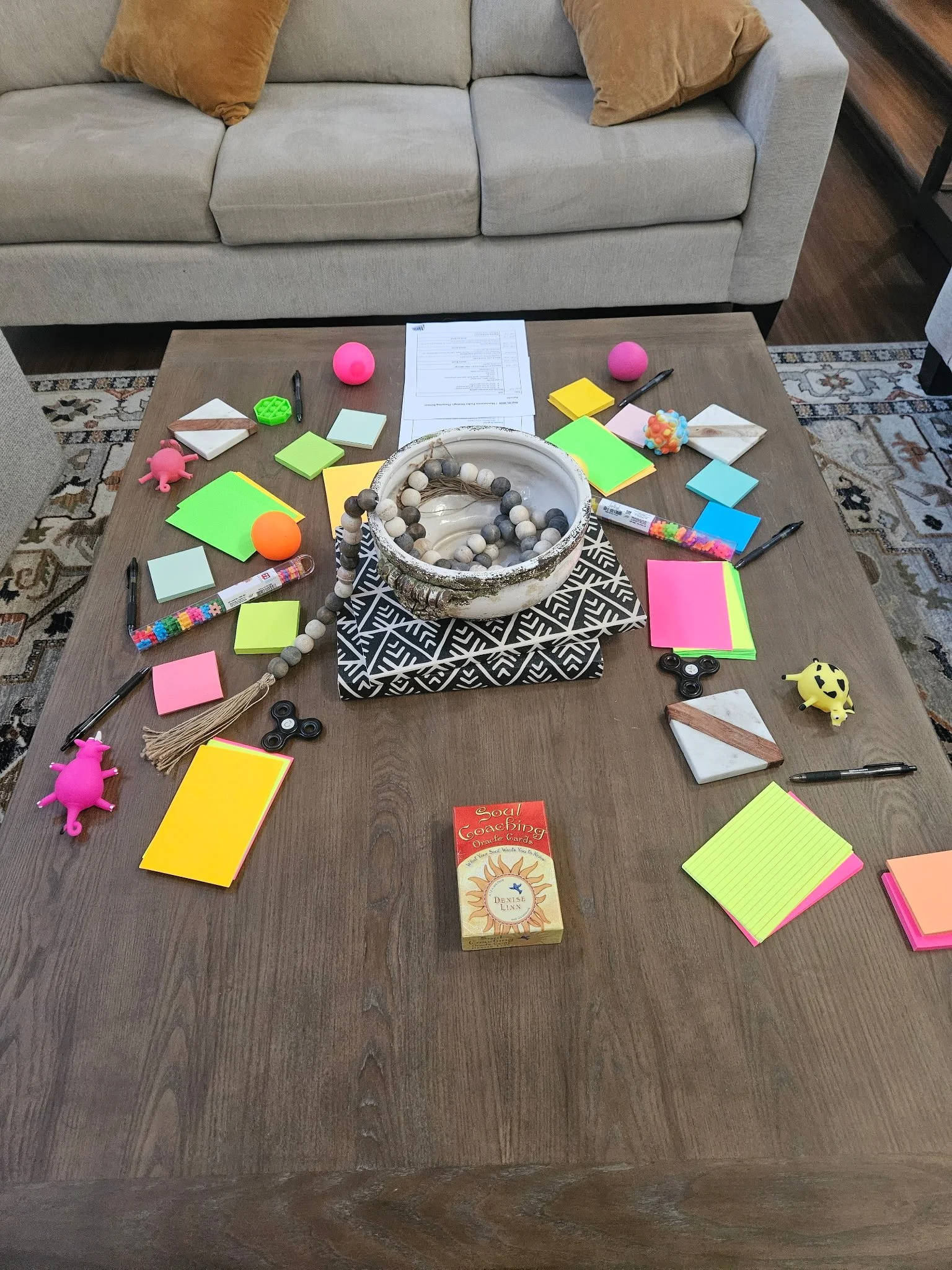 colorful sticky notes on table with other facilitation objects like pens, fidgets and index cards.