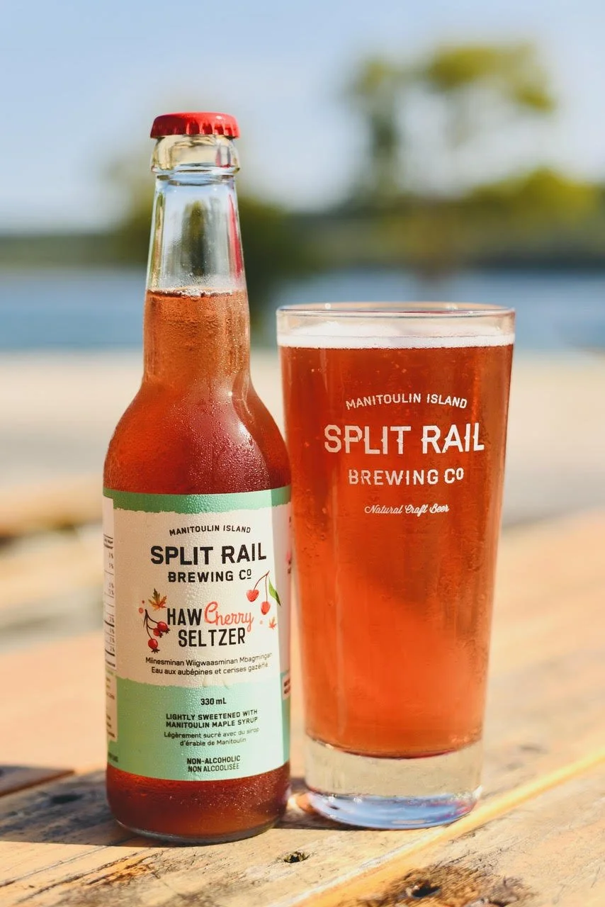 HawCherry Seltzer bottle in the sun, in front of Gore Bay