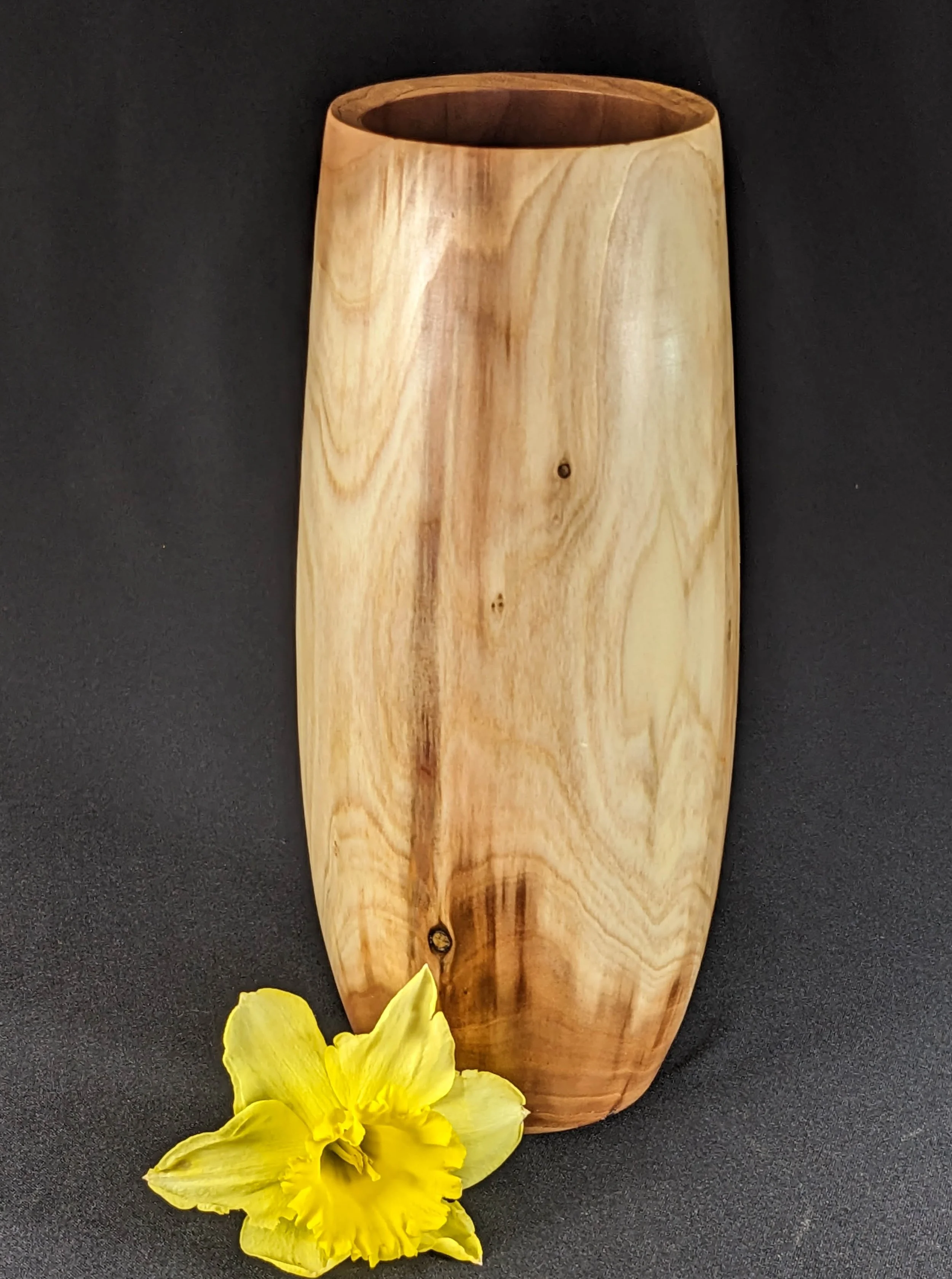 Redwood Vase - Crafted from a young redwood tree that fell during the 2022 drought, this vase celebrates the natural character of the wood. It was turned from a centered log to preserve the subtle, textured surface found just beneath the bark. Its si