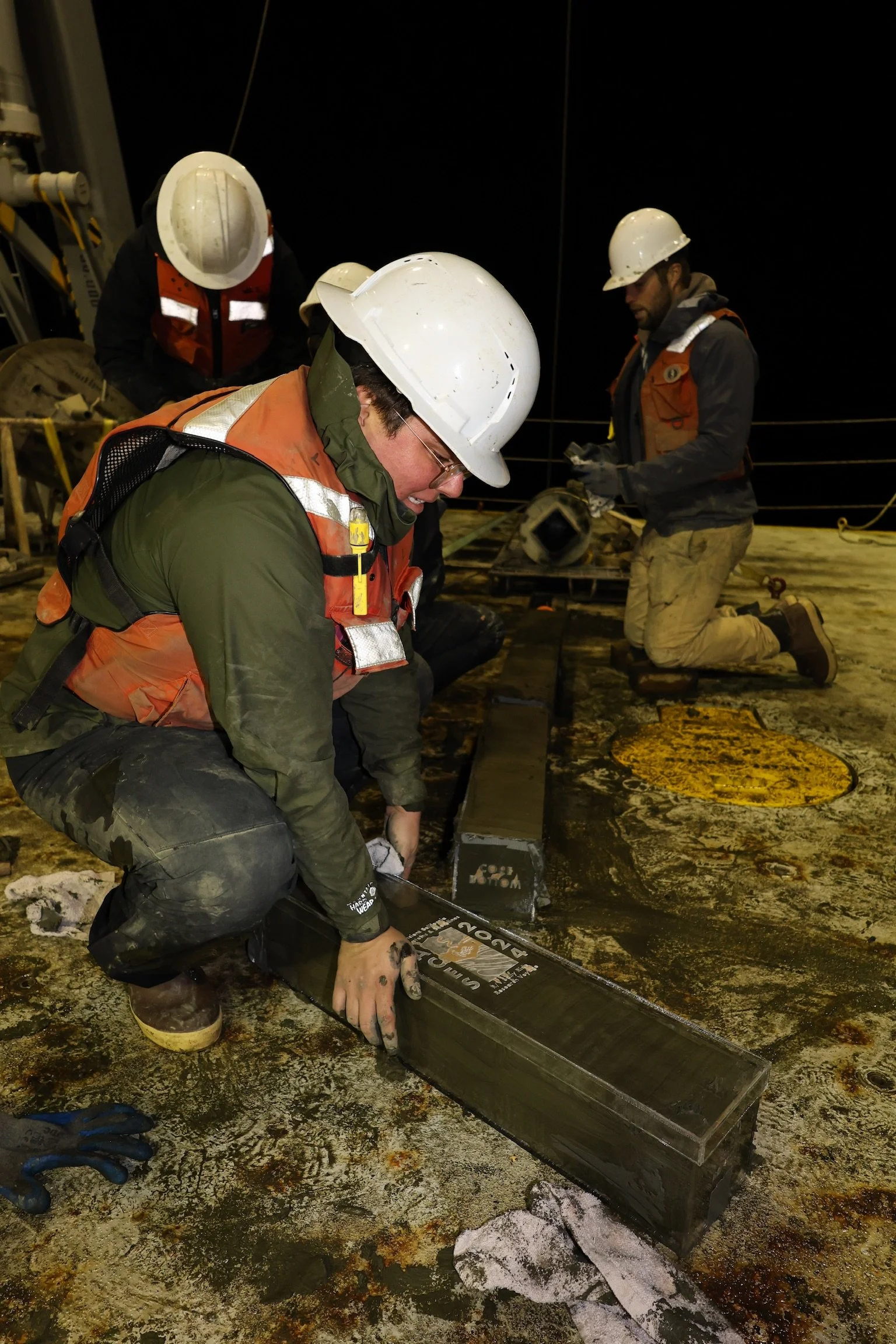 Subsampling a kasten core from the Santa Barbara Basin on the deck of R/V Sally Ride during SR2422 (Ancient California Ecosystems and Shorelines)