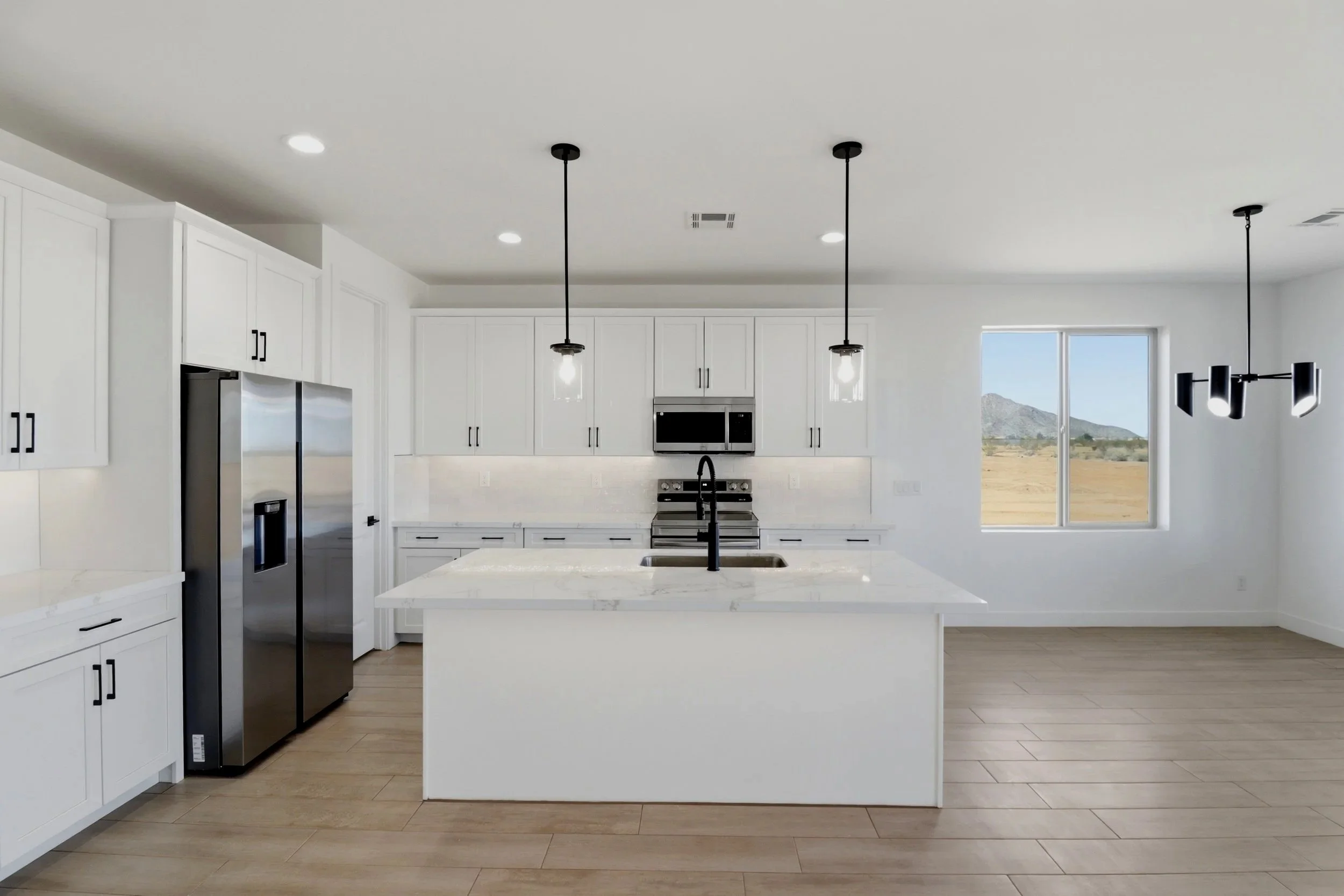 Open concept luxury dining room with modern chandelier and upscale furnishings