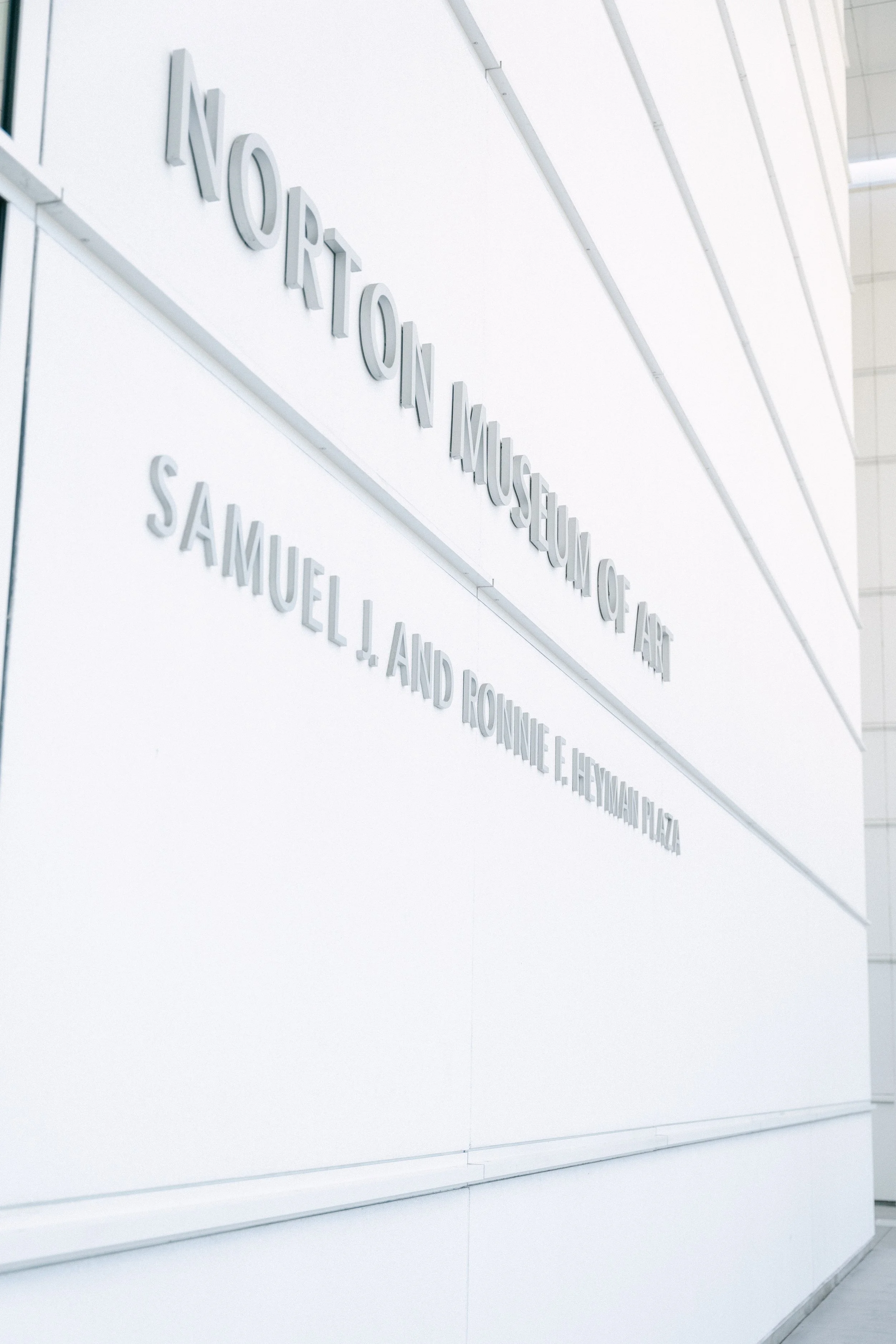 Sign for Norton Museum of Art with the names Samuel J. and Ronnie E. Heyman Plaza below.