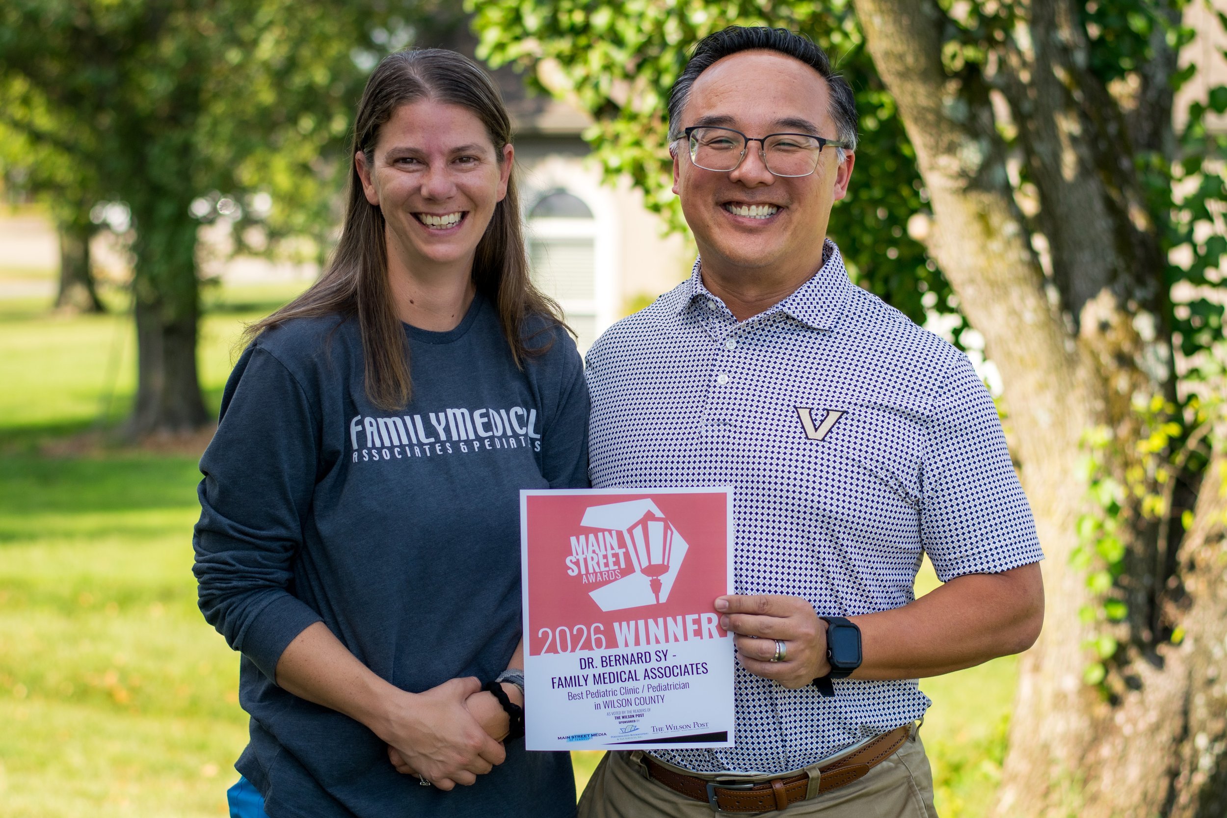 Dr. Bernard Sy and his nurse with their 2026 Best Pediatrician in Wilson County award at Family Medical Associates & Pediatrics in Lebanon, Tennessee