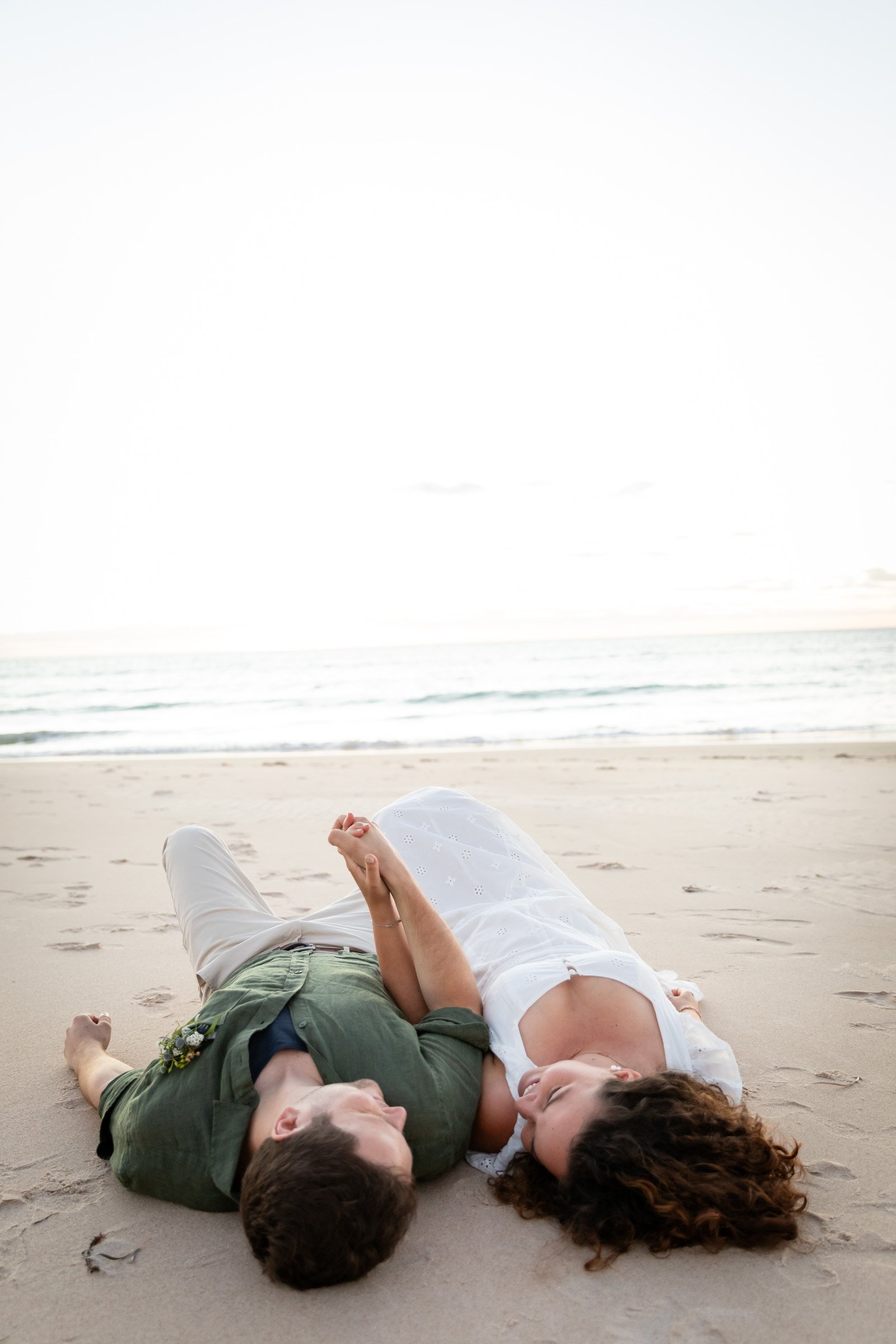 adelaide-maternity-photographer-couple-laying-beach.jpg