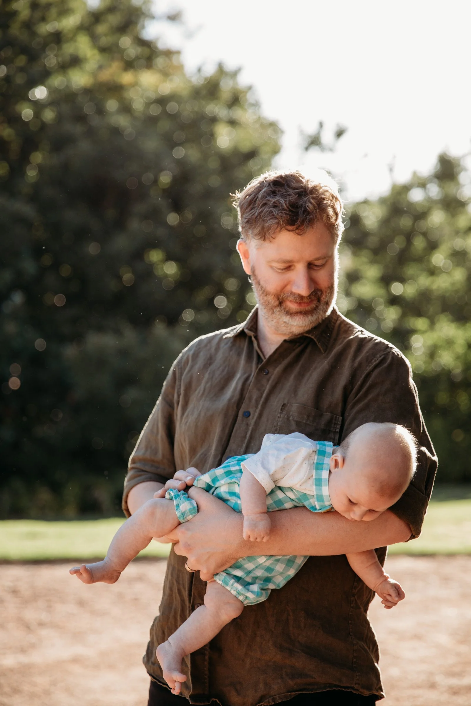 adelaide-family-photographer-father-holding-baby.jpg