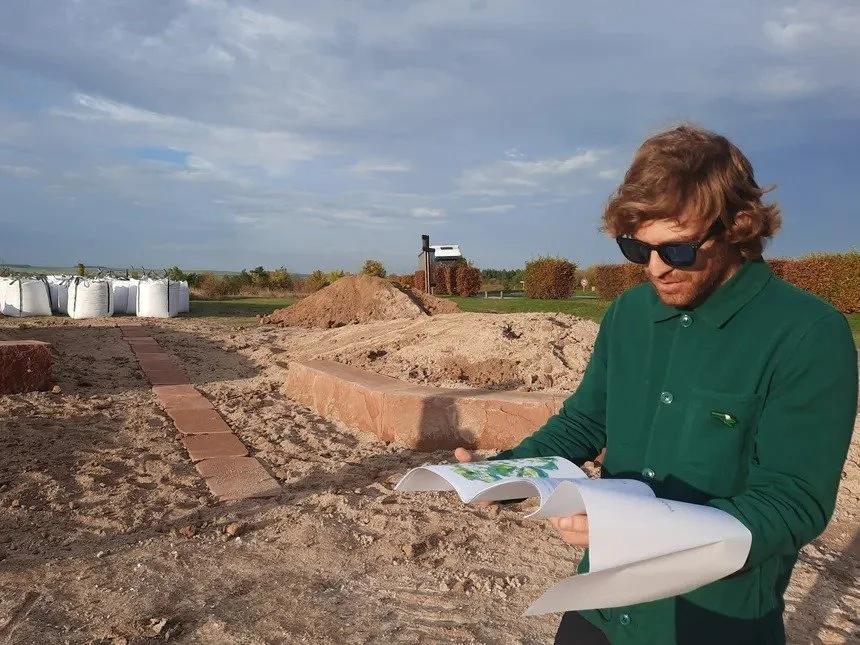 Paris landscape architect reviewing plans on site during the construction of a custom outdoor space