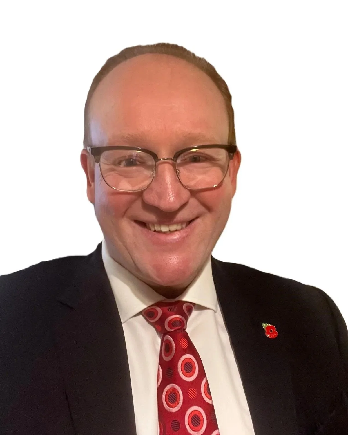 Shane Mason, founder of Strategical, dressed in a suit wearing glasses and smiling