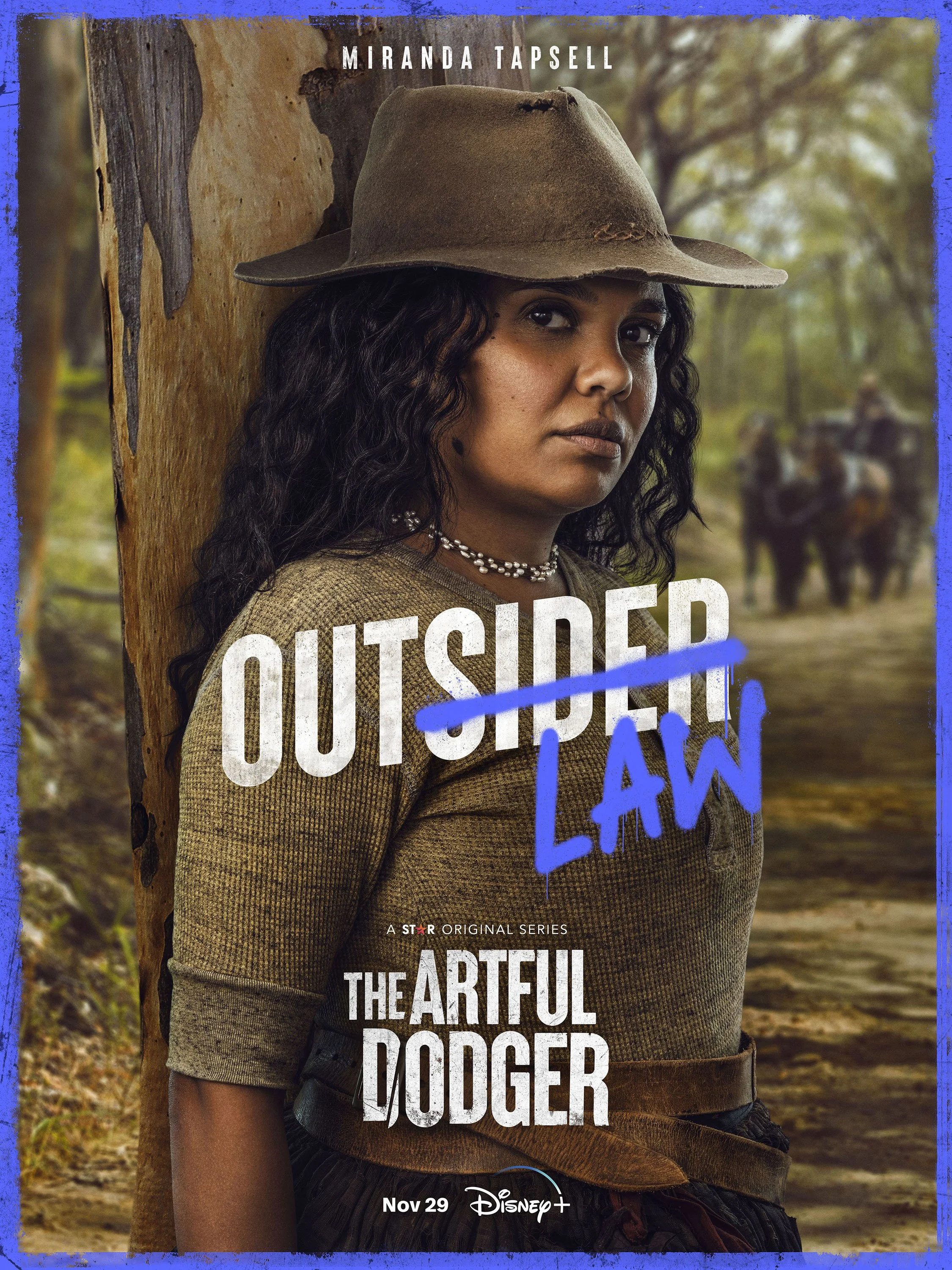 Poster for the series 'The Artful Dodger' featuring a woman with curly dark hair wearing a wide-brimmed hat, standing in a forest setting with horses in the background. The words 'Outsider Law' are crossed out and replaced with 'Law' written in blue 