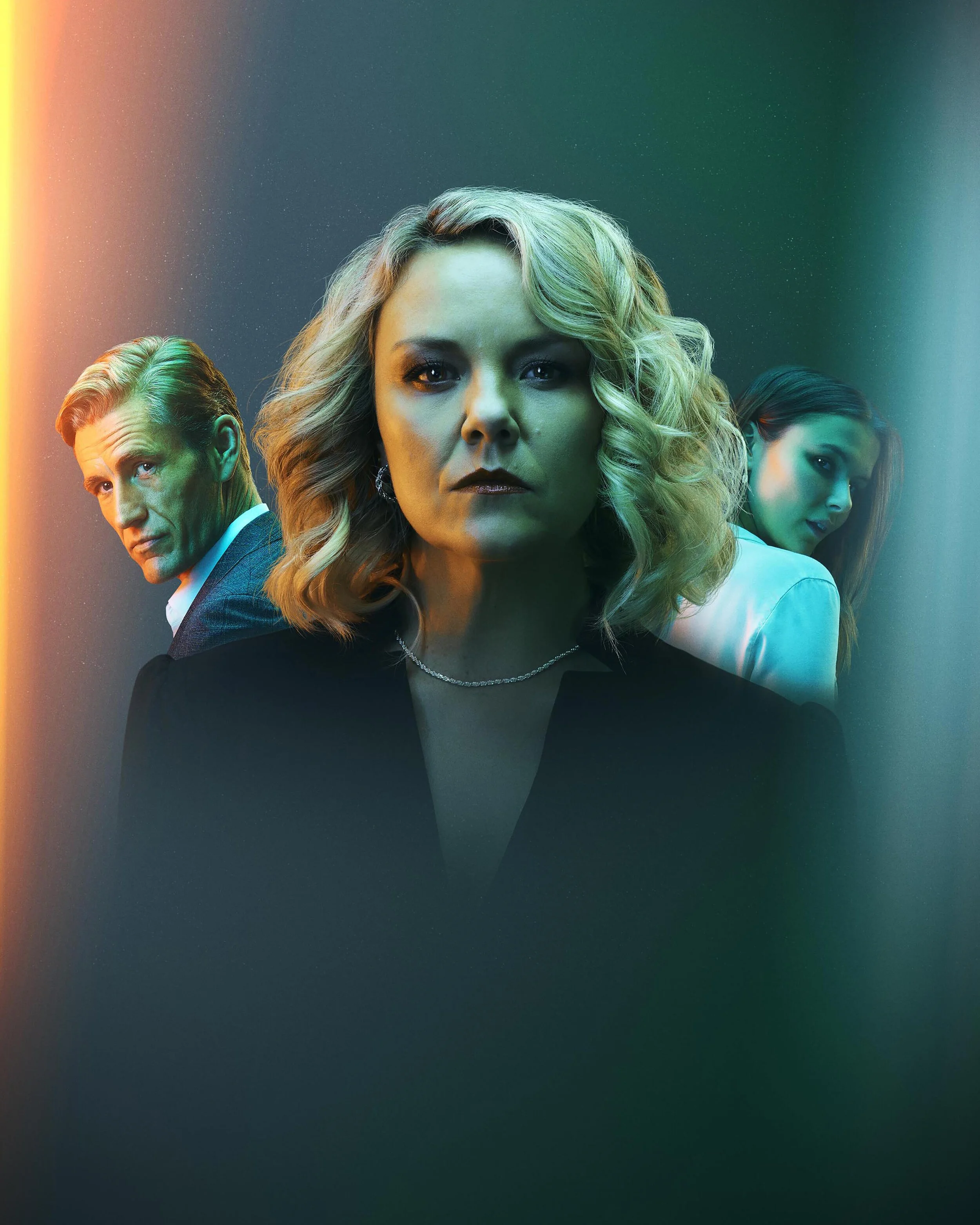 Four adults with serious expressions, posed in a stylized, dimly lit setting with colorful light effects.