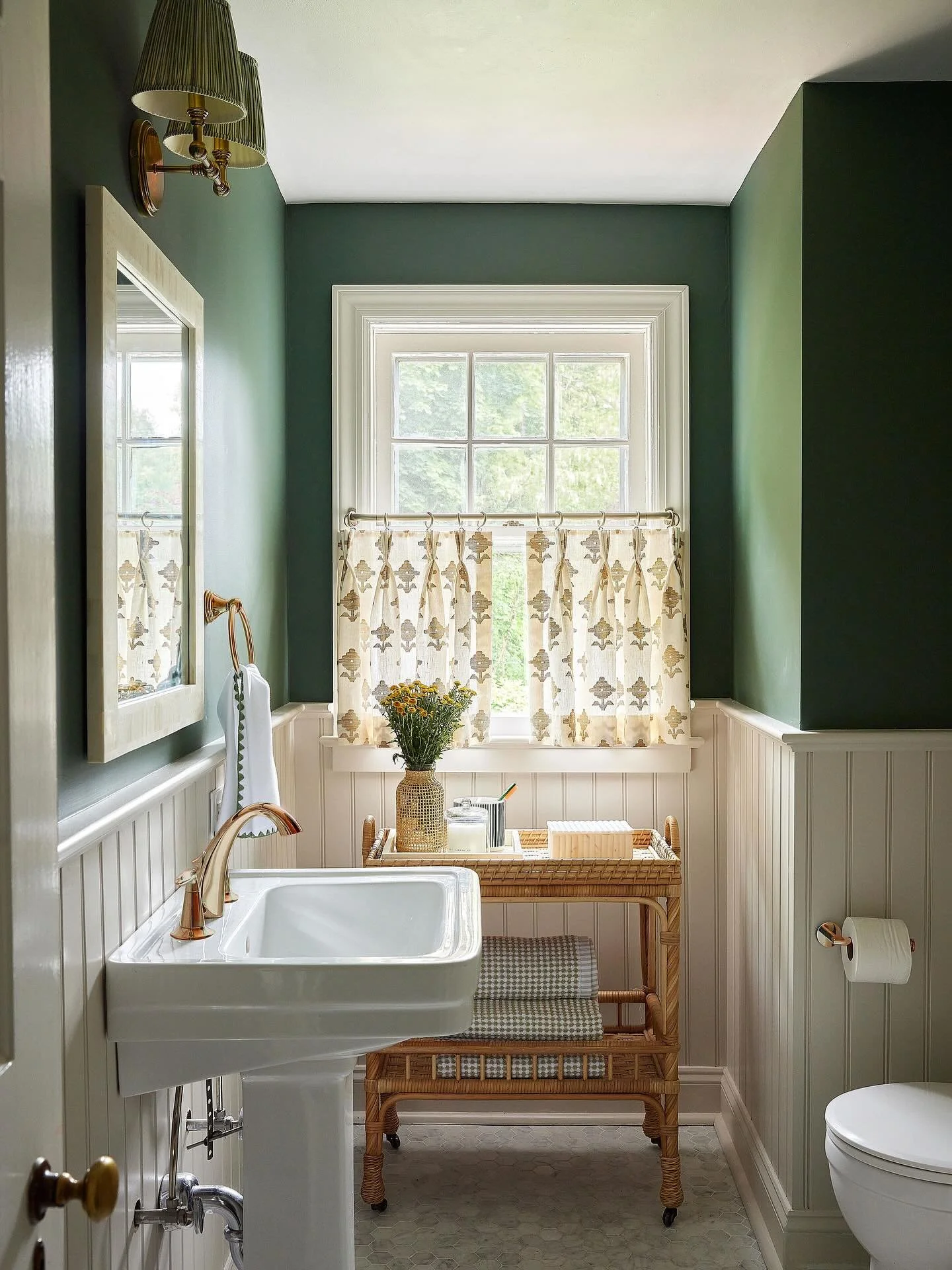 Powder room perfection! Patterned cafe curtains, smoky green walls + a creamy white for the wainscoting created a moody and sophisticated feel ✨

photo: @juliadags 

&bull;
&bull;
&bull;
&bull;

#blueshutterdesign #blueshutterdesignstudio #interiorde