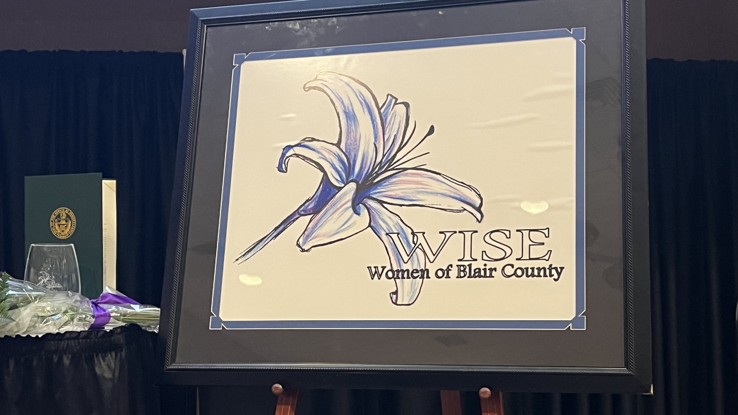April 15, 2026: WISE Women banquet. UU member Kathy Muller accepts the Arts & Letters award for her many outstanding community contributions. “Her vision is rooted in the belief that arts, education and the inclusion of all are vital in creating a co