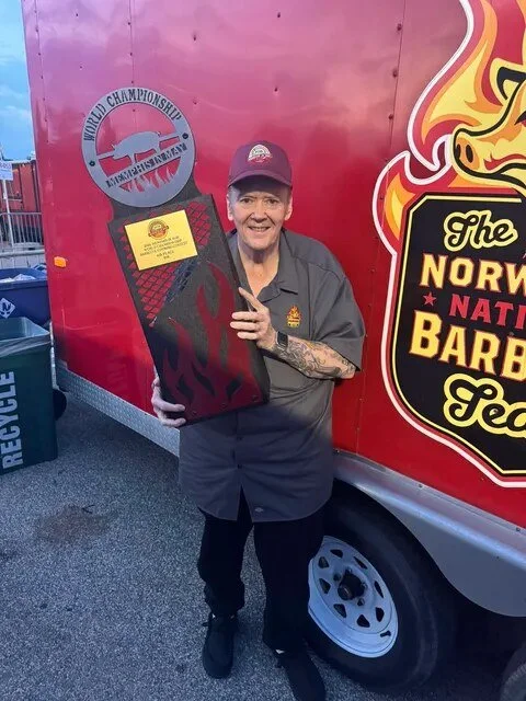 Craig Whitson with the Memphis in May 2026 trophy for 6th place in Ribs, in front of the team trailer