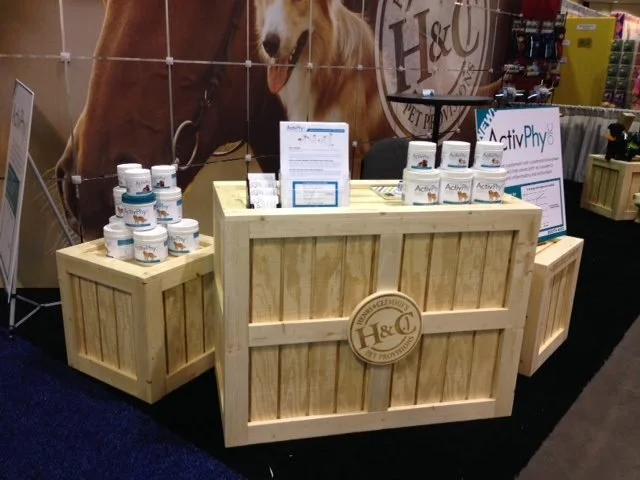 Pine crate counter and side crates displaying products at a trade show booth