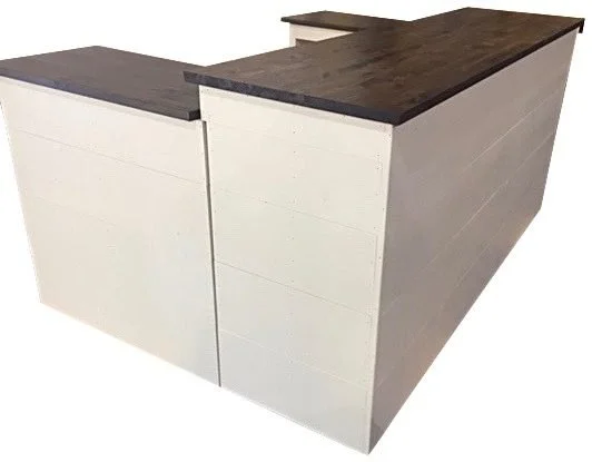 White U-shaped sales counter with walnut tops and wings