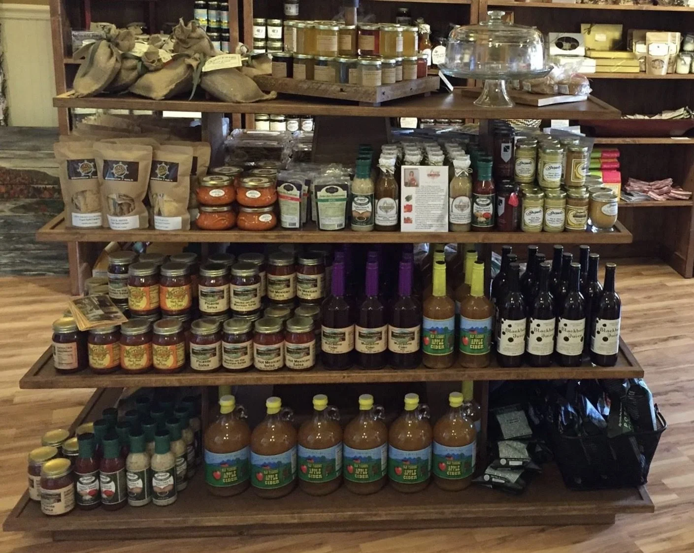 Island gondola in Early American stain stocked with sauces and jams
