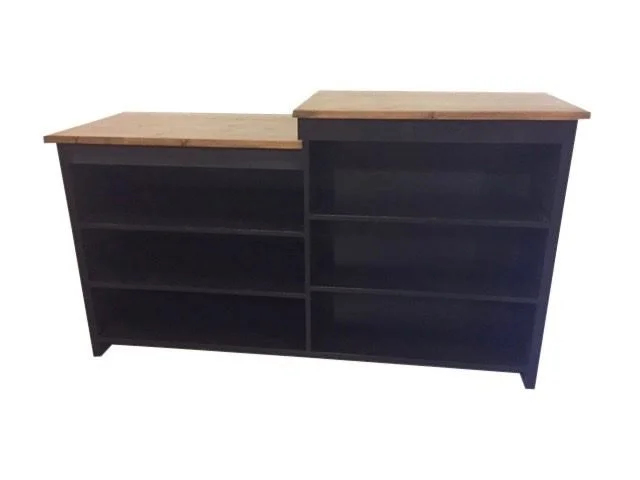 Black two-section sales counter with open shelves and pine tops
