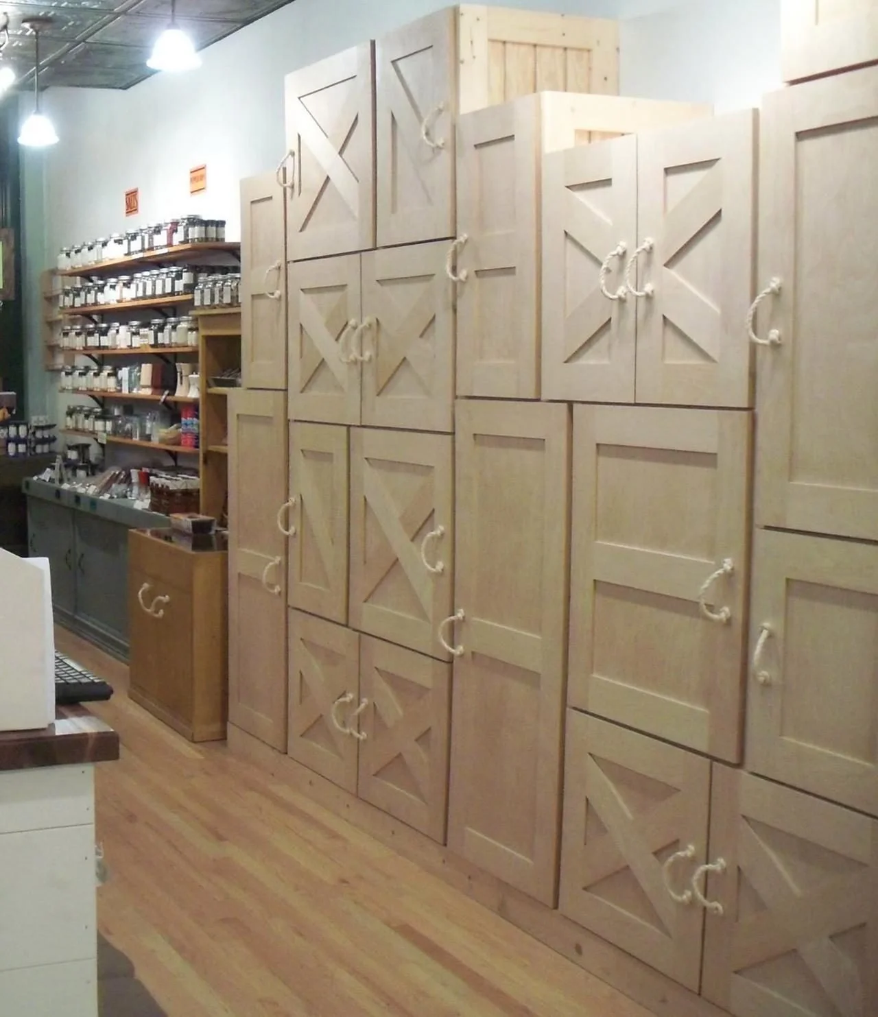 Wall of rustic wood storage cabinets with barn-door fronts in a retail store