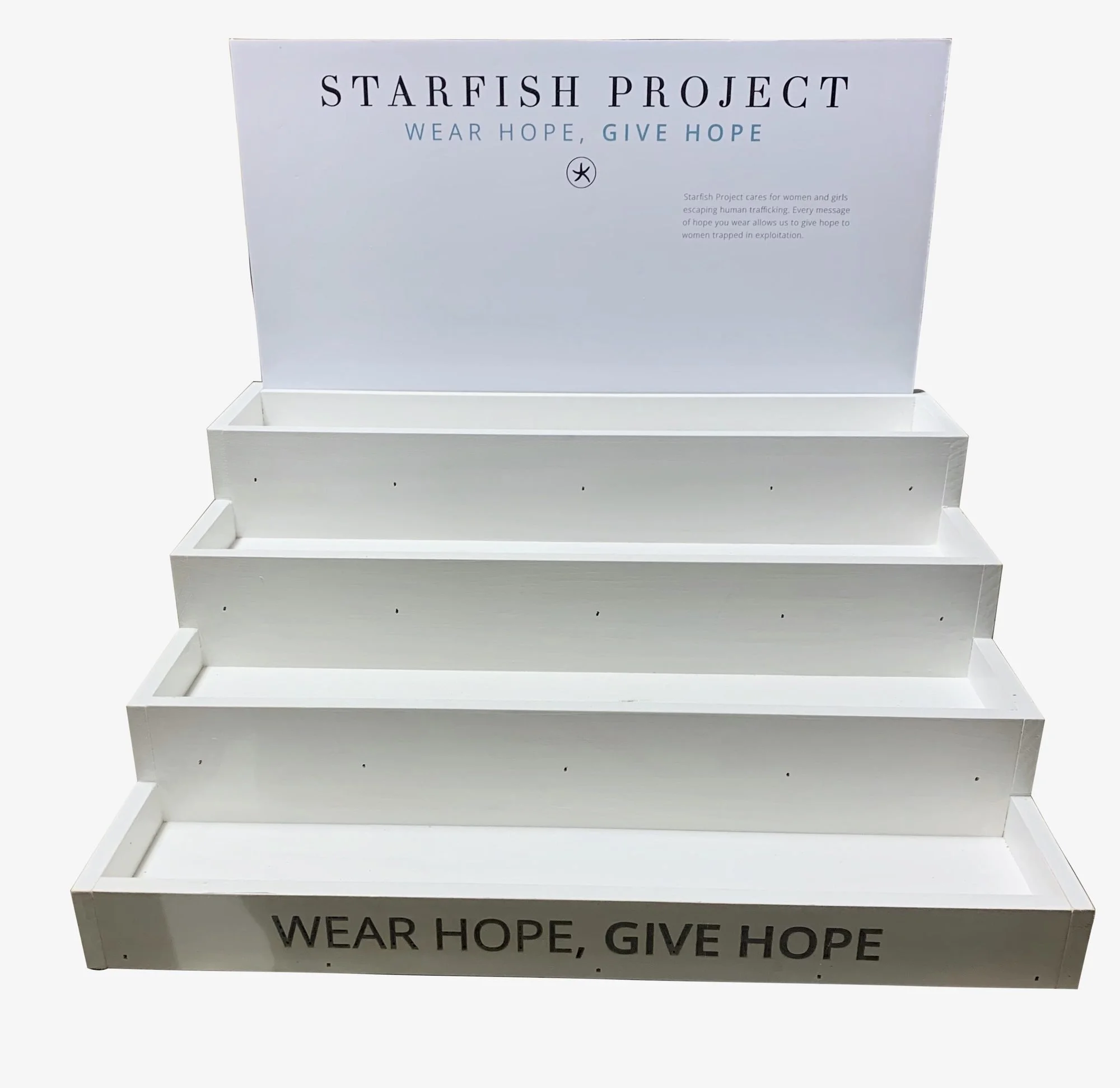 White tiered step display with slotted printed header sign