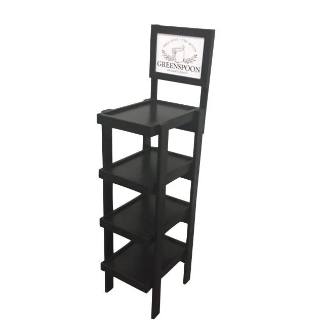 Narrow black floor merchandiser with header sign