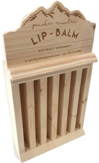 Vertical channel lip balm display with etched header
