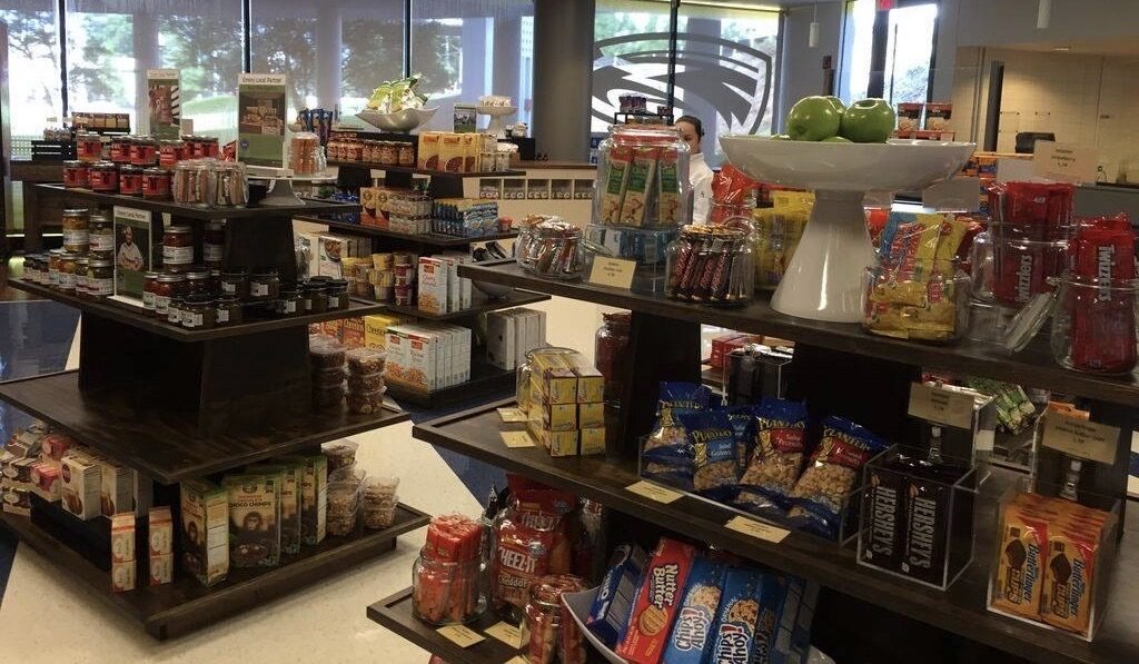 Tiered island gondolas holding snacks and grocery items