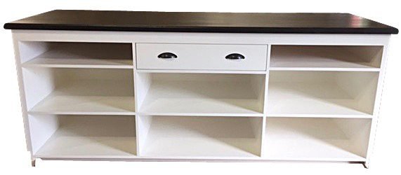 White sales counter with open shelves and a drawer, rear view