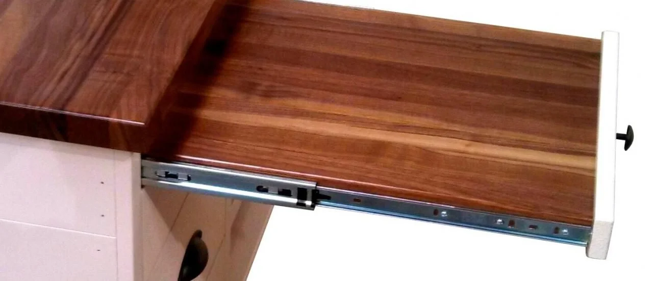 Pull-out butcher block cutting board in a sales counter