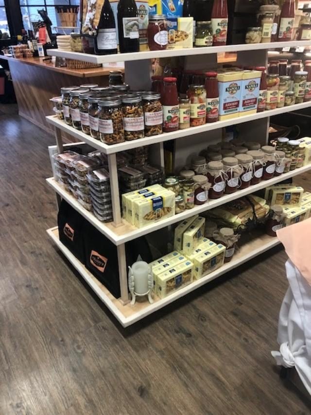 Island gondola with white shelf supports in a specialty food store