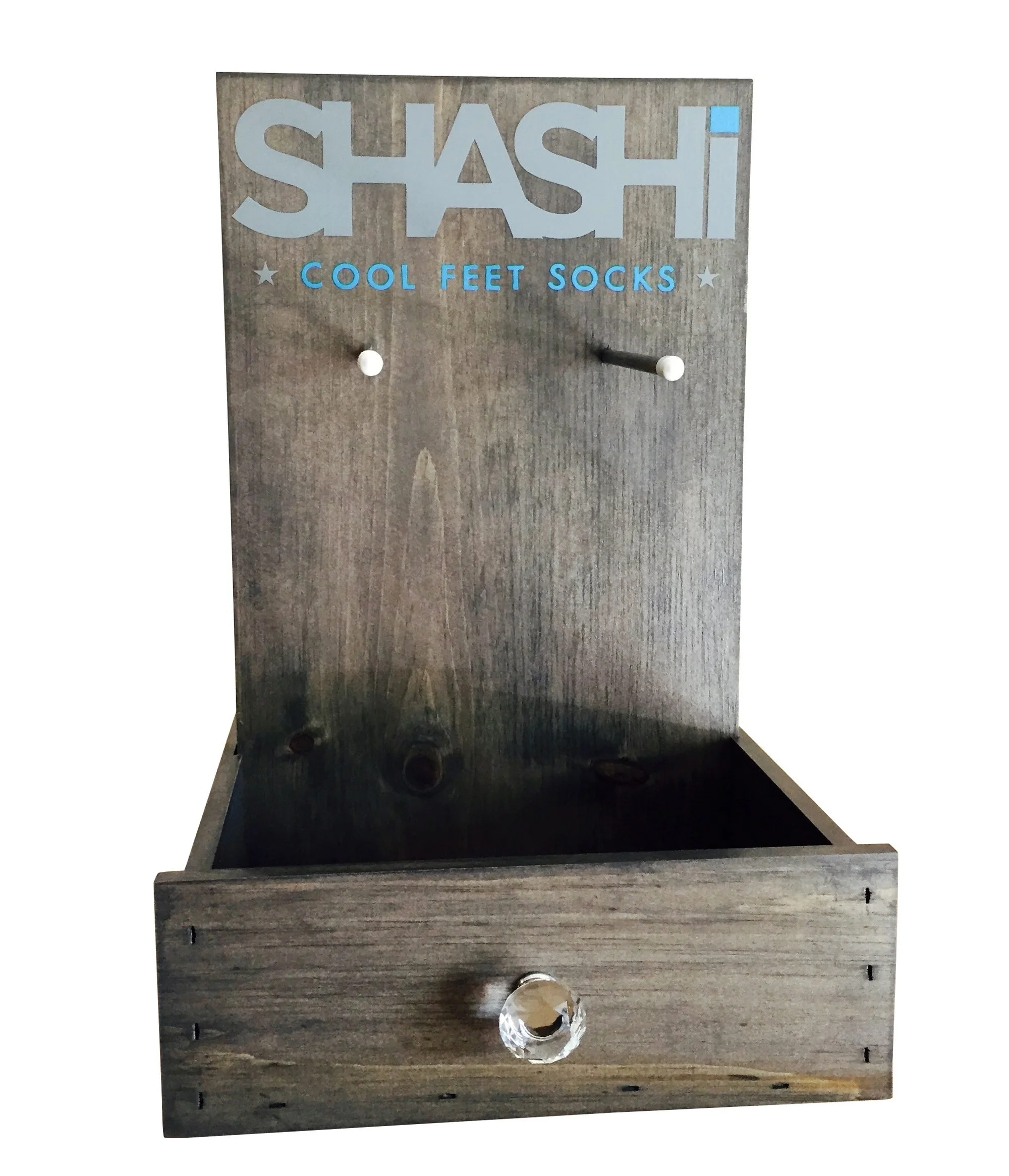 Stained countertop drawer display with peg hooks and printed header