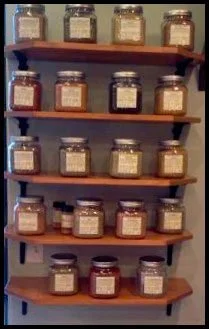 Stained wall-mounted shelves displaying jarred goods