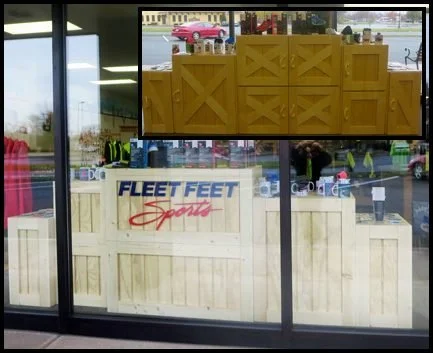 Retail storefront window display built from stacked rustic wood crates