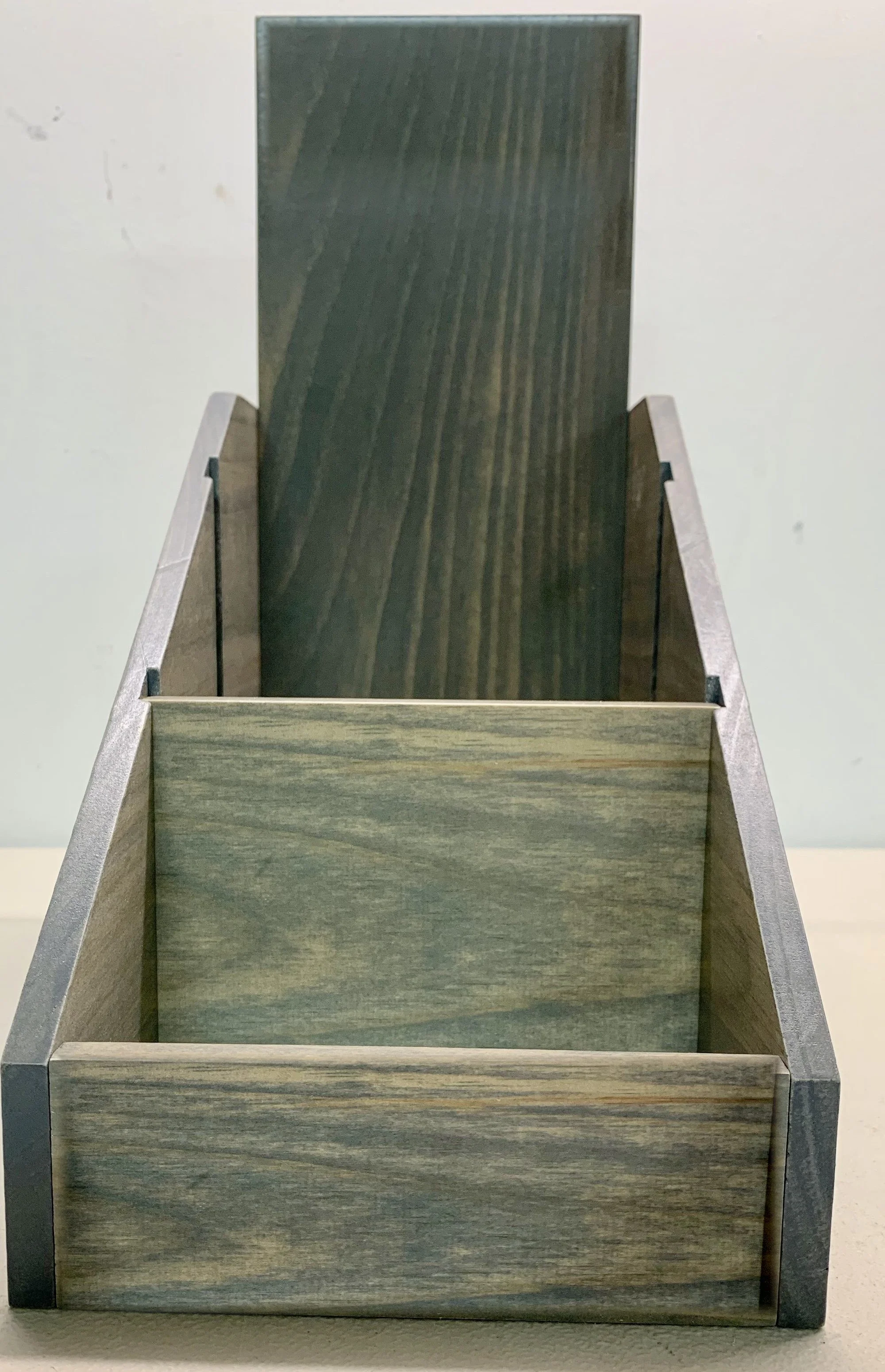 Gray stained countertop display with tall back panel and front bin