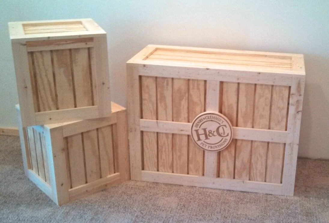Natural pine display crates with a round logo emblem for a trade show booth
