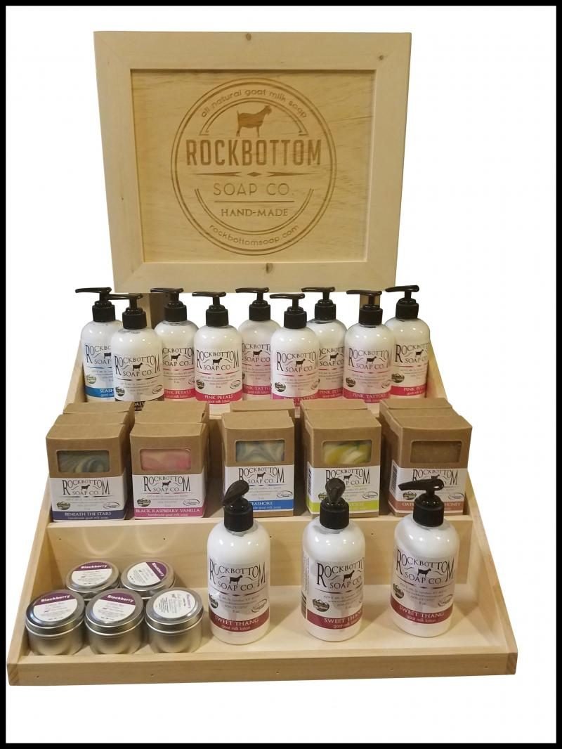 Pine countertop display with etched header stocked with soaps and lotions