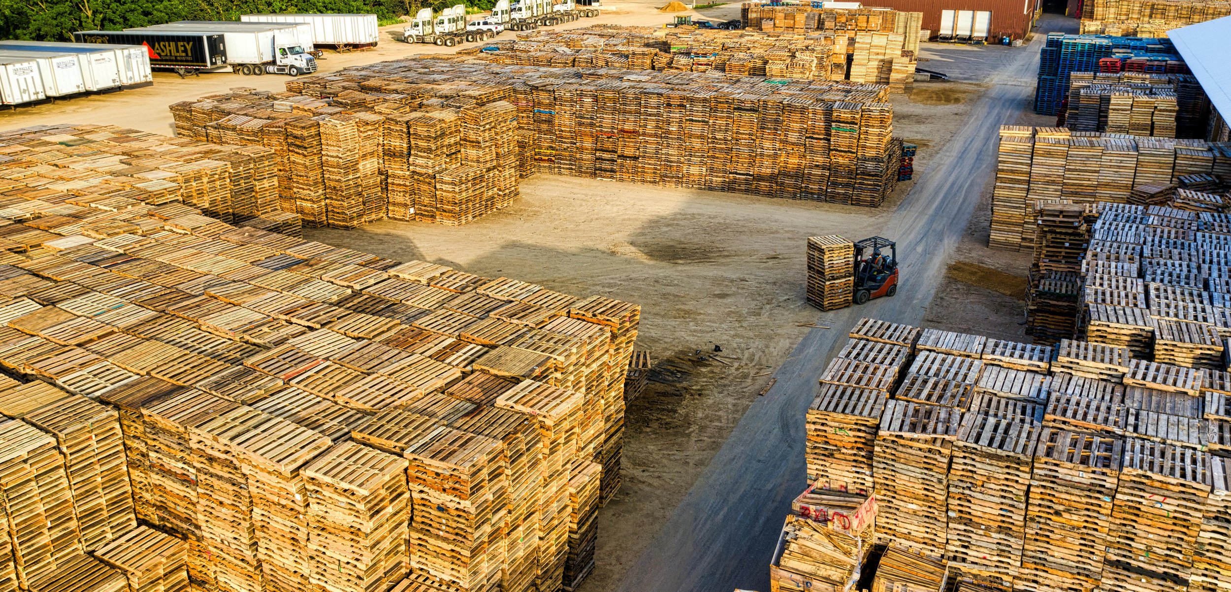 Stack of standard wooden pallets in a warehouse