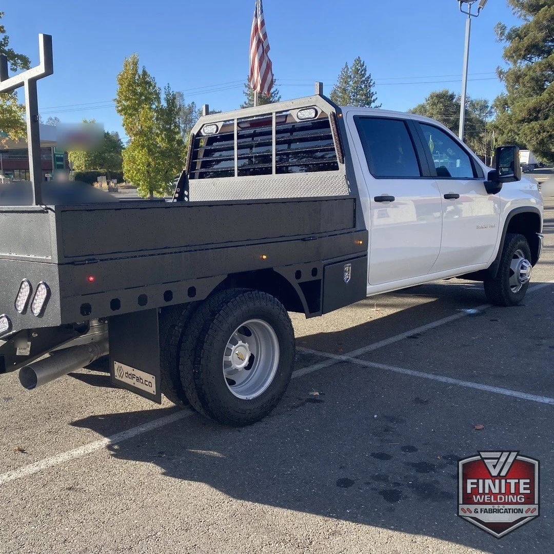 2026 Chevy Silverado 3500 dually rear quarter with wood deck flatbed