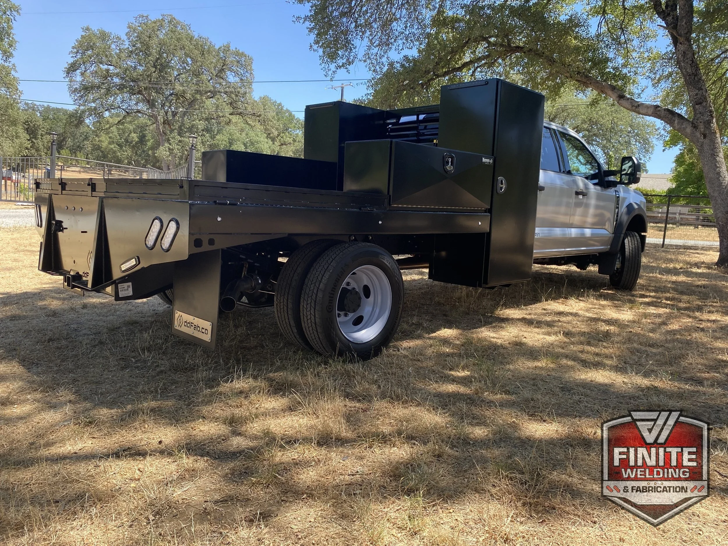 Ford F-450 dually black steel flatbed with toolboxes