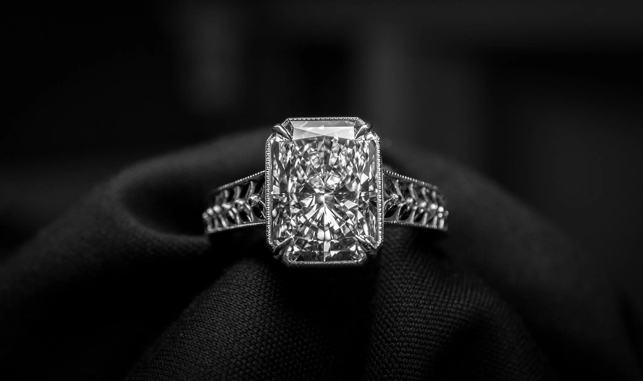 A large emerald cut diamond ring with a detailed platinum band, set by JOSEPH LICATA in Lee's Summit.