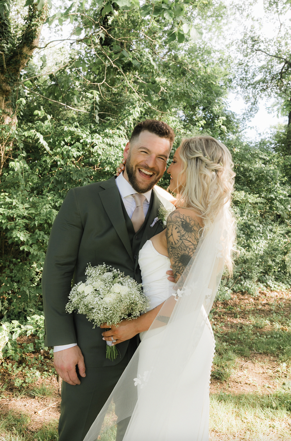 Rae & Co. couple smiling at each other on their wedding day