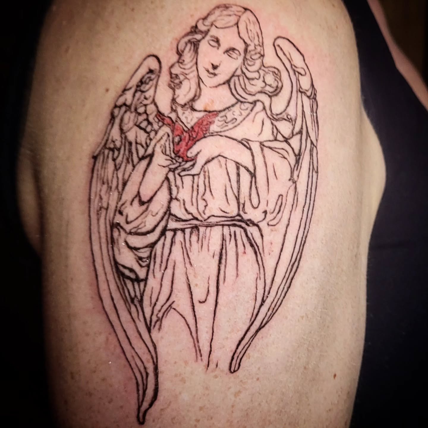 #dentontattooartist #angeltattoo #dfwtattooartist #dentontattoos Here's a beautiful little angel holding a cardinal for Abby in honor of her grandmother who is still here with us. I had such a good time designing this for her. Would your grandmother