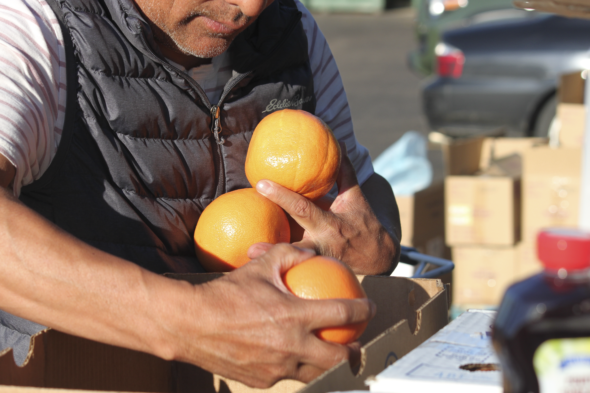Man holding oranges while grocery shopping