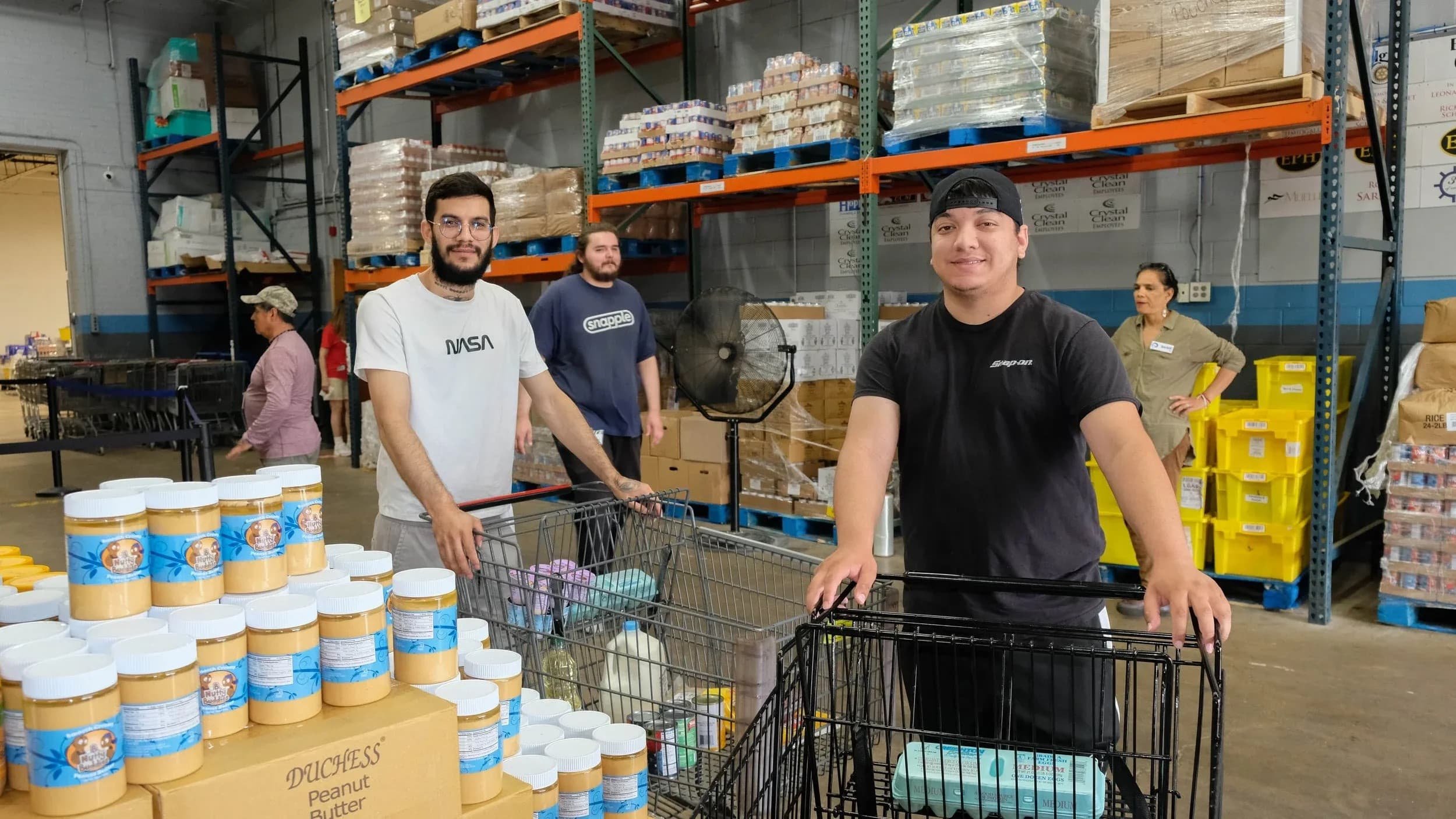 Young friends visiting Food for Greater Elgin's food pantry during distribution.
