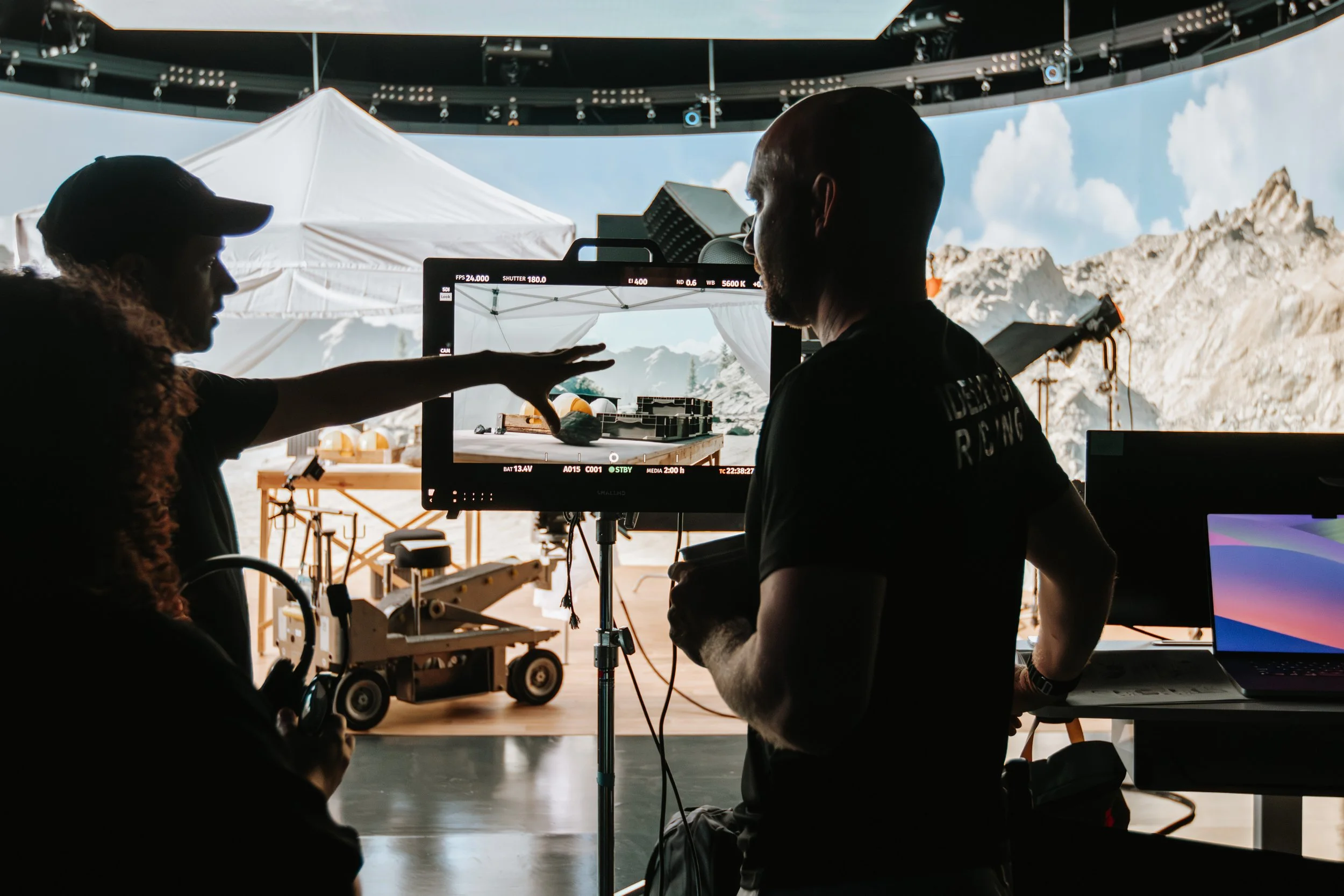 Behind-the-scenes photo of three people reviewing a camera screen on the Amway Traceability Tool shoot.