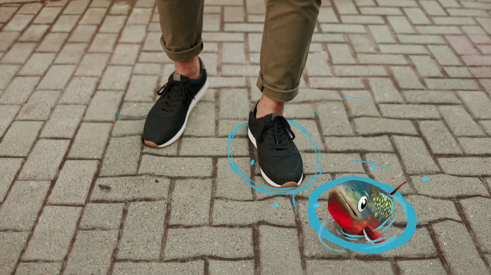 A close-up shot of someone's black sneakers walking on brick paving stone with an animated salmon splashing out of a digital ripple on the ground.