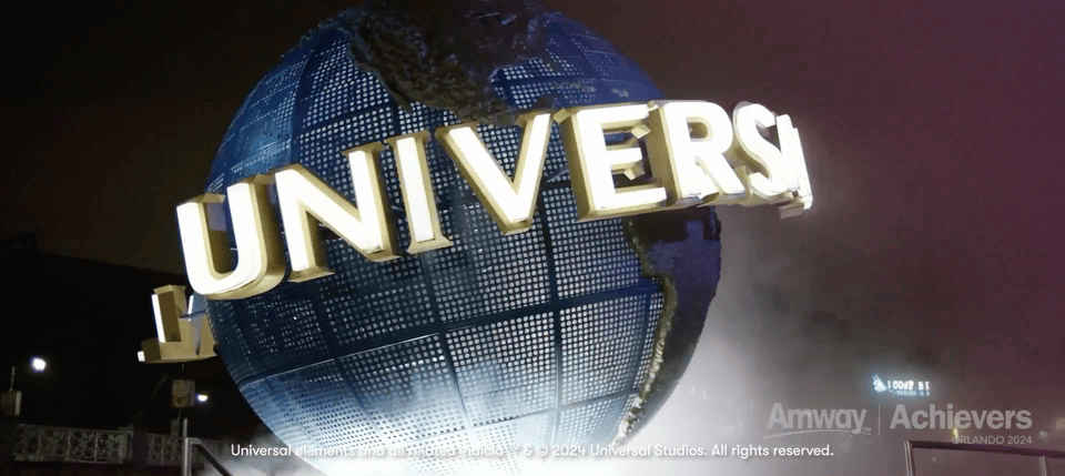 GIF from Amway Achievers 2024 event recap filmed by IDEOLOGY at Universal Studios Orlando, showing attendees celebrating at the park